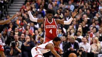 Apr 12, 2016; Toronto, Ontario, CAN; Toronto Raptors guard Kyle Lowry (7) falls to the floor after colliding with Philadelphia 76ers center Nerlens Noel (4) in the first half at Air Canada Centre. Mandatory Credit: Dan Hamilton-USA TODAY Sports