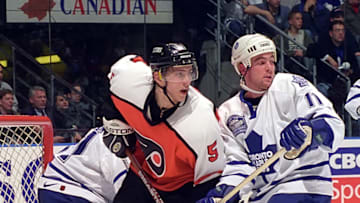 TORONTO, ON - APRIL 22: Steve Sullivan #11 of the Toronto Maple Leafs skates against Dmitri Tertyshny #5 of the Philadelphia Flyers during the 1999 NHL Semi-Final playoff game action at Air Canada Centre in Toronto, Ontario, Canada. (Photo by Graig Abel/Getty Images)