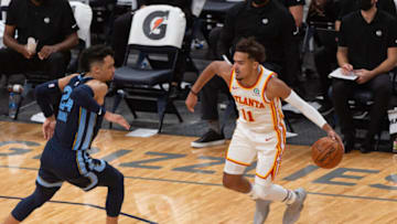 Atlanta Hawks guard Trae Young (11) handles the ball against Memphis Grizzlies guard Dillon Brooks (24) during the first half at FedExForum. Mandatory Credit: Justin Ford-USA TODAY Sports