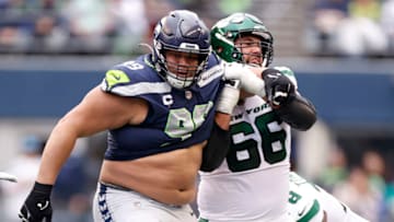 SEATTLE, WASHINGTON - JANUARY 01: Al Woods #99 of the Seattle Seahawks and Laurent Duvernay-Tardif #66 of the New York Jets in action during the second quarter at Lumen Field on January 01, 2023 in Seattle, Washington. (Photo by Steph Chambers/Getty Images)