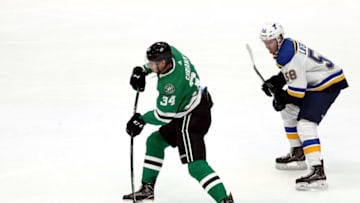 DALLAS, TEXAS - SEPTEMBER 16: Denis Gurianov #34 of the Dallas Stars skates the puck against Mathias Laferriere #58 of the St. Louis Blues in the third period during a NHL preseason game at American Airlines Center on September 16, 2019 in Dallas, Texas. (Photo by Ronald Martinez/Getty Images)
