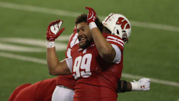 Dec 19, 2020; Madison, Wisconsin, USA; Wisconsin Badgers defensive end Isaiah Mullens (99) dances between the third and fourth quarters in the game against the Minnesota Golden Gophers during the second half at Camp Randall Stadium. Mandatory Credit: Mary Langenfeld-USA TODAY Sports