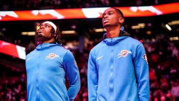 Shai Gilgeous-Alexander #2 and Luguentz Dort #5 of the Oklahoma City Thunder stand for the Canadian national anthem before playing the Toronto Raptors in their basketball game at the Scotiabank Arena on December 8, 2021 in Toronto, Ontario, Canada. (Photo by Mark Blinch/Getty Images)