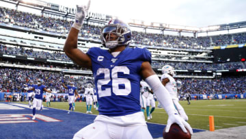 EAST RUTHERFORD, NEW JERSEY - DECEMBER 15: Saquon Barkley #26 of the New York Giants celebrates his touchdown in the fourth quarter against the Miami Dolphins at MetLife Stadium on December 15, 2019 in East Rutherford, New Jersey.The New York Giants defeated the Miami Dolphins 31-13. (Photo by Elsa/Getty Images)