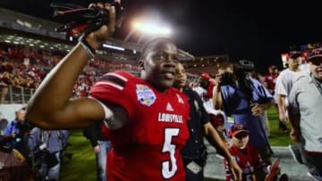 Dec 28, 2013; Orlando, FL, USA; Louisville Cardinals quarterback Teddy Bridgewater (5) celebrates after the Russell Athletic Bowl against the Miami Hurricanes at Florida Citrus Bowl Stadium. Mandatory Credit: David Manning-USA TODAY Sports