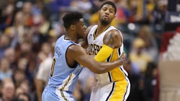 Jan 30, 2016; Indianapolis, IN, USA; Indiana Pacers forward Paul George (13) is guarded by Denver Nuggets forward Emmanuel Mudiay (0) at Bankers Life Fieldhouse. Indiana defeats Denver 109-105 in overtime. Mandatory Credit: Brian Spurlock-USA TODAY Sports