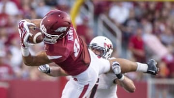 Sep 20, 2014; Fayetteville, AR, USA; Arkansas Razorbacks tight end Hunter Henry (84) pulls down a pass as Northern Illinois Huskies linebacker Michael Santacaterina (7) looks on during the first half of a game at Donald W. Reynolds Razorback Stadium. Mandatory Credit: Beth Hall-USA TODAY Sports
