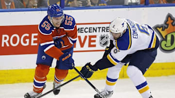 Oct 15, 2015; Edmonton, Alberta, CAN; Edmonton Oilers forward Mark Letestu (55) and St. Louis Blues defensemen Joel Edmundson (6) battle for a loose puck during the second period at Rexall Place. Mandatory Credit: Perry Nelson-USA TODAY Sports