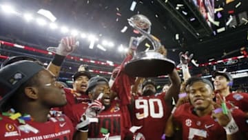 Dec 31, 2015; Arlington, TX, USA; Alabama Crimson Tide players including Cyrus Jones (5) and defensive lineman Jarran Reed (90) celebrate after defeating the Michigan State Spartans in the 2015 CFP semifinal at the Cotton Bowl at AT&T Stadium. Mandatory Credit: Tim Heitman-USA TODAY Sports