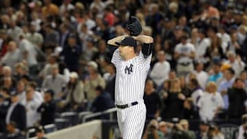 Sep 6, 2013; Bronx, NY, USA; New York Yankees relief pitcher Boone Logan (48) reacts after allowing a game-tying grand slam home run to Boston Red Sox first baseman Mike Napoli (not pictured) during the seventh inning of a game at Yankee Stadium. Mandatory Credit: Brad Penner-USA TODAY Sports