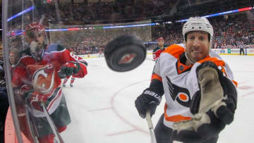 Feb 16, 2016; Newark, NJ, USA; Philadelphia Flyers left wing R.J. Umberger (20) reaches for the puck during the third period at Prudential Center. The Flyers defeated the Devils 6-3. Mandatory Credit: Ed Mulholland-USA TODAY Sports