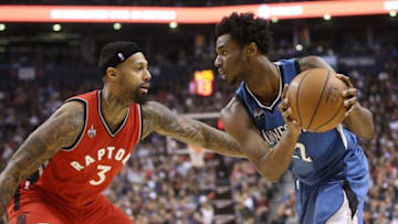Feb 24, 2016; Toronto, Ontario, CAN; Minnesota Timberwolves forward Andrew Wiggins (22) controls the ball as Toronto Raptors forward James Johnson (3) defends at Air Canada Centre. Mandatory Credit: Tom Szczerbowski-USA TODAY Sports