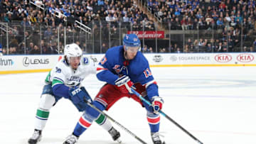 NEW YORK, NY - NOVEMBER 12: Kevin Hayes #13 of the New York Rangers skates with the puck against Brendan Gaunce #50 of the Vancouver Canucks at Madison Square Garden on November 12, 2018 in New York City. (Photo by Jared Silber/NHLI via Getty Images)