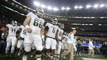 Dec 31, 2015; Arlington, TX, USA; Michigan State Spartans head coach Mark Dantonio leads his team to the field before the 2015 CFP semifinal at the Cotton Bowl against the Alabama Crimson Tide at AT&T Stadium. Mandatory Credit: Tim Heitman-USA TODAY Sports
