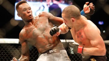 Robert Whittaker of Australia (R) punches Israel Adesanya of New Zealand (L) during the middleweight title bout of the UFC 243 fight night in Melbourne on October 6, 2019. (Photo by ASANKA BRENDON RATNAYAKE / AFP) / -- IMAGE RESTRICTED TO EDITORIAL USE - STRICTLY NO COMMERCIAL USE -- (Photo by ASANKA BRENDON RATNAYAKE/AFP via Getty Images)