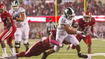 Oct 1, 2016; Bloomington, IN, USA; Michigan State Spartans running back Gerald Holmes (24) runs the ball and is tackled by Indiana Hoosiers linebacker Marcus Oliver (44) in the second half of the game at Memorial Stadium. Indiana Hoosiers beat the Michigan State Spartans by the score of 24-21. Mandatory Credit: Trevor Ruszkowski-USA TODAY Sports