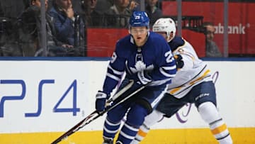 TORONTO, ON - APRIL 2: William Nylander #29 of the Toronto Maple Leafs turns with the puck against Casey Nelson #8 of the Buffalo Sabres during an NHL game at the Air Canada Centre on April 2, 2018 in Toronto, Ontario, Canada. The Maple Leafs defeated the Sabres 5-2. (Photo by Claus Andersen/Getty Images)