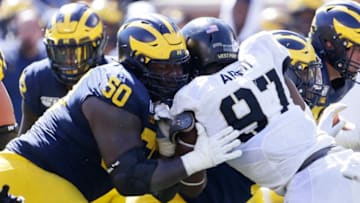 ANN ARBOR, MI - SEPTEMBER 07: Offensive lineman Michael Onwenu #50 of the Michigan Wolverines blocks against defensive lineman Kwabena Bonsu #97 of the Army Black Knights during the second half at Michigan Stadium on September 7, 2019 in Ann Arbor, Michigan. (Photo by Duane Burleson/Getty Images)