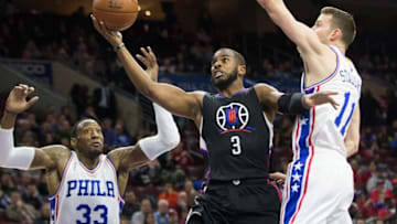 Feb 8, 2016; Philadelphia, PA, USA; Los Angeles Clippers guard Chris Paul (3) shoots the ball between Philadelphia 76ers forward Robert Covington (33) and guard Nik Stauskas (11) during the first quarter at Wells Fargo Center. Mandatory Credit: Bill Streicher-USA TODAY Sports