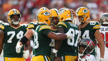 Sep 25, 2022; Tampa, Florida, USA; Green Bay Packers wide receiver Romeo Doubs (87) is congratulated by quarterback Aaron Rodgers (12) after scoring a touchdown against the Tampa Bay Buccaneers in the first quarterat Raymond James Stadium. Mandatory Credit: Nathan Ray Seebeck-USA TODAY Sports