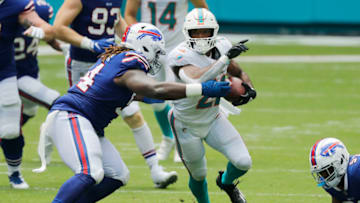 MIAMI GARDENS, FLORIDA - SEPTEMBER 20: Matt Breida #22 of the Miami Dolphins is tackled by Vernon Butler #94 of the Buffalo Bills during the first half at Hard Rock Stadium on September 20, 2020 in Miami Gardens, Florida. (Photo by Michael Reaves/Getty Images)