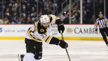 Feb 11, 2016; Winnipeg, Manitoba, CAN; Boston Bruins center Patrice Bergeron (37) shoots the puck on net during the first period against the Winnipeg Jets at the MTS Centre. Mandatory Credit: Bruce Fedyck-USA TODAY Sports