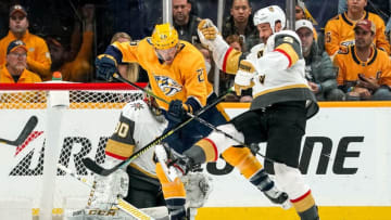 NASHVILLE, TN - NOVEMBER 27: Daniel Carr #26 of the Nashville Predators battles in front of the net against Cody Glass #9 and Malcolm Subban #30 of the Vegas Golden Knights at Bridgestone Arena on November 27, 2019 in Nashville, Tennessee. (Photo by John Russell/NHLI via Getty Images)