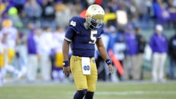 Dec 30, 2014; Nashville, TN, USA; Notre Dame Fighting Irish quarterback Everett Golson (5) walks off the field after being hit on a play during the first half against the LSU Tigers in the Music City Bowl at LP Field. Mandatory Credit: Christopher Hanewinckel-USA TODAY Sports