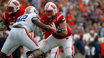 Jan 1, 2015; Tampa, FL, USA; Wisconsin Badgers offensive lineman Tyler Marz (61) blocks as Auburn Tigers defensive lineman Gimel President (42) rushes during the first half in the 2015 Outback Bowl at Raymond James Stadium. Mandatory Credit: Kim Klement-USA TODAY Sports
