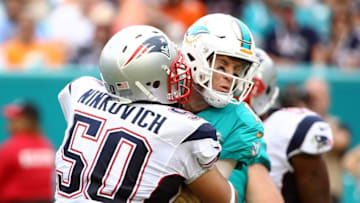 Jan 3, 2016; Miami Gardens, FL, USA;New England Patriots defensive end Rob Ninkovich (50) hit Miami Dolphins quarterback Ryan Tannehill (17) during the second half at Sun Life Stadium. The Dolphins won 20-10. Mandatory Credit: Steve Mitchell-USA TODAY Sports