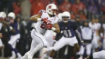Nov 7, 2015; Seattle, WA, USA; Utah Utes running back Devontae Booker (23) rushes the ball against the Washington Huskies during the second quarter at Husky Stadium. Mandatory Credit: Jennifer Buchanan-USA TODAY Sports