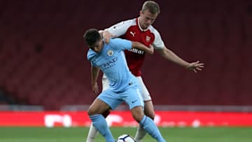 LONDON, ENGLAND - AUGUST 21: Tyreke Wilson of Manchester City and Rob Holding of Arsenal battle for possesion during the Premier League 2 match between Arsenal v Manchester City at Emirates Stadium on August 21, 2017 in London, England. (Photo by James Chance/Getty Images)