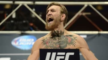 Jul 10, 2015; Las Vegas, NV, USA; Conor McGregor steps on the scale for his bout against Chad Mendes (not pictured) during weigh-ins for UFC 189 at MGM Grand Garden Arena. Mandatory Credit: Joe Camporeale-USA TODAY Sports