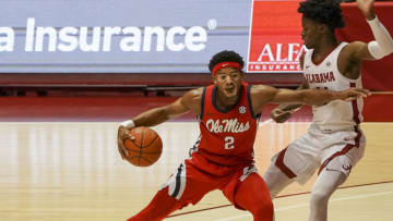Dec 29, 2020; Tuscaloosa, Alabama, USA; Mississippi Rebels guard Devontae Shuler (2) pushes away Alabama Crimson Tide guard Keon Ellis (14) during the first half at Coleman Coliseum. Mandatory Credit: Marvin Gentry-USA TODAY Sports