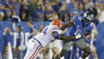 Sep 19, 2015; Lexington, KY, USA; Kentucky Wildcats running back Stanley Boom Williams (18) runs the ball against Florida Gators defensive lineman Bryan Cox (94) during the game at Commonwealth Stadium. Florida defeated Kentucky 14-9. Mandatory Credit: Mark Zerof-USA TODAY Sports