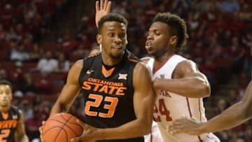 Feb 24, 2016; Norman, OK, USA; Oklahoma State Cowboys guard Leyton Hammonds (23) prepares to shoot the ball as Oklahoma Sooners guard Buddy Hield (24) defend during the first half at Lloyd Noble Center. Mandatory Credit: Mark D. Smith-USA TODAY Sports