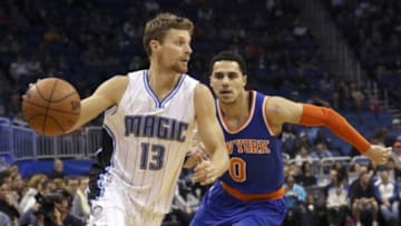 Feb 11, 2015; Orlando, FL, USA; Orlando Magic guard Luke Ridnour (13) drives past New York Knicks guard Shane Larkin (0) during the first quarter at Amway Center. Mandatory Credit: Reinhold Matay-USA TODAY Sports