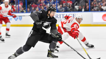 TAMPA, FL - MARCH 09: Tampa Bay Lightning center Yanni Gourde (37) takes a backhand shot as he is pressured by Detroit Red Wings defender Danny DeKeyser (65) during the third period of an NHL game between the Detroit Red Wings and the Tampa Bay Lightning on March 09, 2019 at Amalie Arena in Tampa, FL. (Photo by Roy K. Miller/Icon Sportswire via Getty Images)