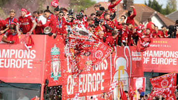 LIVERPOOL, ENGLAND - JUNE 02: Alex Oxlade-Chamberlain, Daniel Sturridge, Alberto Moreno, Trent Alexander-Arnold and Adam Lallana of Liverpool with the UEFA Champions League trophy on board a parade bus after winning the UEFA Champions League final against Tottenham Hotspur in Madrid on June 2, 2019 in Liverpool, England. (Photo by Nigel Roddis/Getty Images)