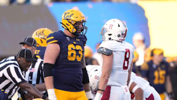 Nov 19, 2022; Berkeley, California, USA; California Golden Bears offensive lineman Brayden Rohme (63) talks to Stanford Cardinal linebacker Tristan Sinclair (8) during the second quarter at FTX Field at California Memorial Stadium. Mandatory Credit: Darren Yamashita-USA TODAY Sports
