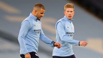 Manchester City's English defender Kyle Walker (L) and Manchester City's Belgian midfielder Kevin De Bruyne (R) warm up ahead of the English Premier League football match between Manchester City and Crystal Palace at the Etihad Stadium in Manchester, north west England, on January 17, 2021. (Photo by Clive Brunskill / POOL / AFP) / RESTRICTED TO EDITORIAL USE. No use with unauthorized audio, video, data, fixture lists, club/league logos or 'live' services. Online in-match use limited to 120 images. An additional 40 images may be used in extra time. No video emulation. Social media in-match use limited to 120 images. An additional 40 images may be used in extra time. No use in betting publications, games or single club/league/player publications. / (Photo by CLIVE BRUNSKILL/POOL/AFP via Getty Images)