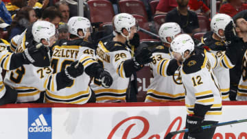 SUNRISE, FL - JANUARY 28: Teammates congratulate Craig Smith #12 of the Boston Bruins after he scored a first period goal against the Florida Panthers at the FLA Live Arena on January 28, 2023 in Sunrise, Florida. (Photo by Joel Auerbach/Getty Images)
