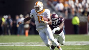 Oct 8, 2016; College Station, TX, USA; Tennessee Volunteers quarterback Joshua Dobbs (11) eludes Texas A&M Aggies defensive lineman Jarrett Johnson (40) during the first quarter at Kyle Field. Mandatory Credit: Jerome Miron-USA TODAY Sports