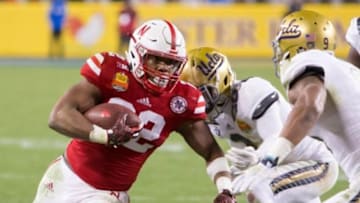 Dec 26, 2015; Santa Clara, CA, USA; Nebraska Cornhuskers running back Devine Ozigbo (22) is tackled by UCLA Bruins defensive back Jaleel Wadood (2) in the second half at Levi