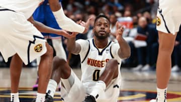JaMychal Green #0 of the Denver Nuggets is helped up by teammates during the second half of the game against the New York Knicks at Ball Arena on February 8, 2022 in Denver, Colorado. (Photo by Justin Tafoya/Getty Images)