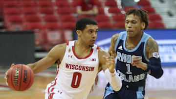 Dec 9, 2020; Madison, Wisconsin, USA; Wisconsin Badgers guard D'Mitrik Trice (0) dribbles the ball as Rhode Island Rams guard Fatts Russell (1) defends at the Kohl Center. Mandatory Credit: Mary Langenfeld-USA TODAY Sports