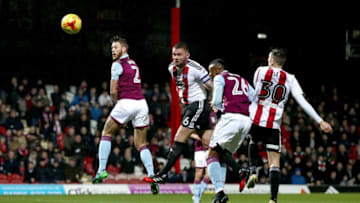 BRENTFORD, ENGLAND - JANUARY 31: Harlee Dean of Brentford heads at goal during the Sky Bet Championship match between Brentford and Aston Villa at Griffin Park on January 31, 2017 in Brentford, England. (Photo by Clive Rose/Getty Images)