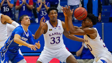 Dec 8, 2020; Lawrence, Kansas, USA; Kansas Jayhawks guard Ochai Agbaji (30) and forward David McCormack (33) and Creighton Bluejays guard Marcus Zegarowski (11) fight for a loose ball during the first half at Allen Fieldhouse. Mandatory Credit: Jay Biggerstaff-USA TODAY Sports