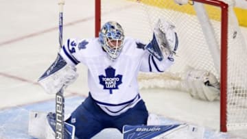Feb 9, 2016; Calgary, Alberta, CAN; Toronto Maple Leafs goalie James Reimer (34) attempts to make a save against Calgary Flames defenseman Dougie Hamilton (not pictured) during the second period at Scotiabank Saddledome. Mandatory Credit: Candice Ward-USA TODAY Sports