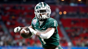 ATLANTA, GEORGIA - DECEMBER 30: Jayden Reed #1 of the Michigan State Spartans celebrates scoring a touchdown in the first quarter of the game against the Pittsburgh Panthers during the Chick-Fil-A Peach Bowl at Mercedes-Benz Stadium on December 30, 2021 in Atlanta, Georgia. (Photo by Todd Kirkland/Getty Images)
